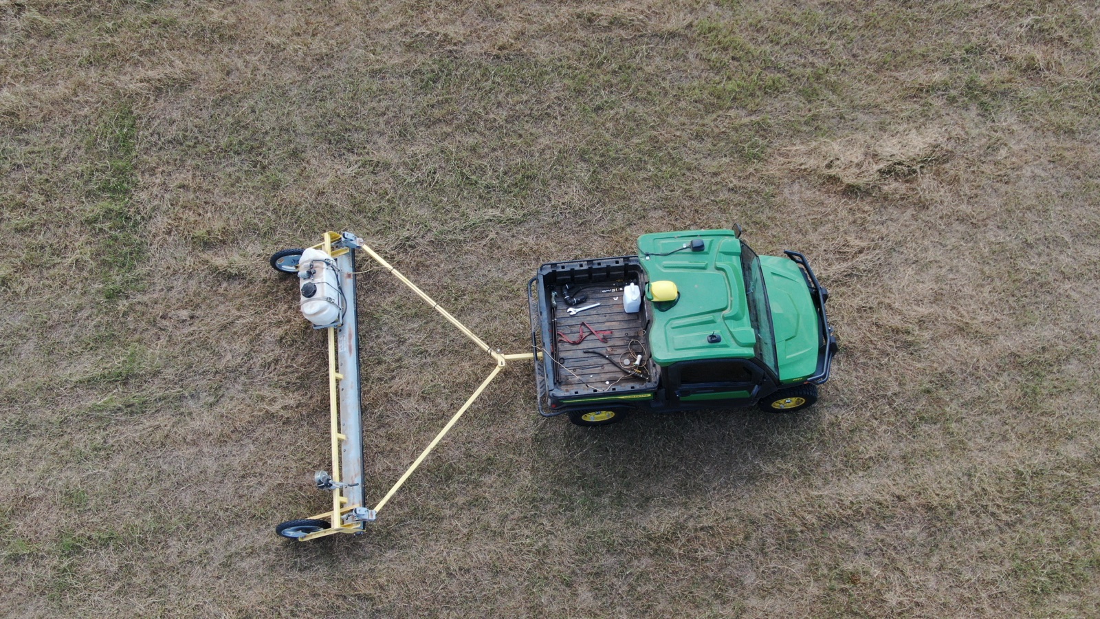 Aerial view of a spray rig working in a field